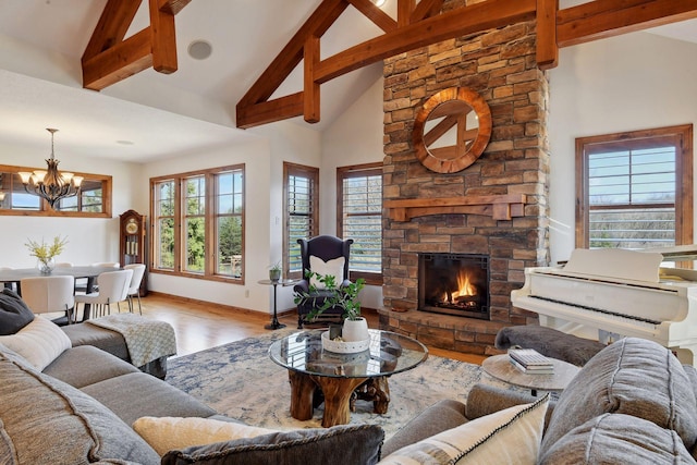 living room featuring beam ceiling, a chandelier, high vaulted ceiling, light wood-type flooring, and a fireplace