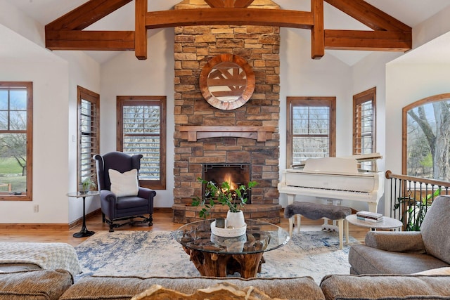 living room with hardwood / wood-style flooring, a fireplace, high vaulted ceiling, and beam ceiling