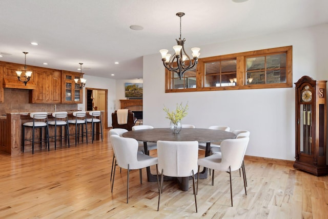 dining area featuring an inviting chandelier and light hardwood / wood-style floors