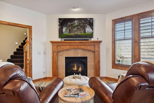 living room with wood-type flooring and a fireplace