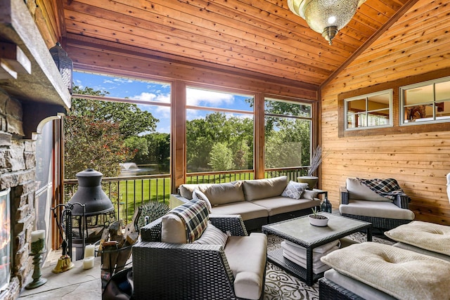 sunroom with a fireplace, wood ceiling, and vaulted ceiling