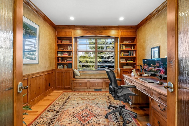 office space with built in features and light wood-type flooring