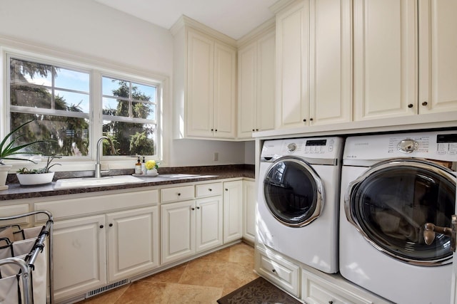 laundry area with washer and dryer, sink, cabinets, and light tile patterned flooring