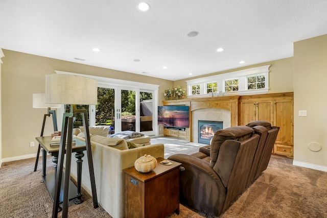 carpeted living room featuring a tiled fireplace