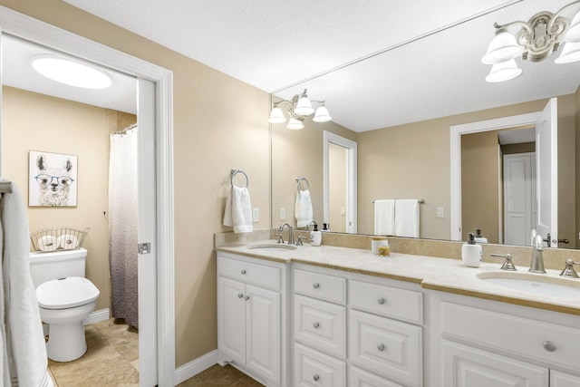 bathroom with vanity, toilet, and tile patterned flooring