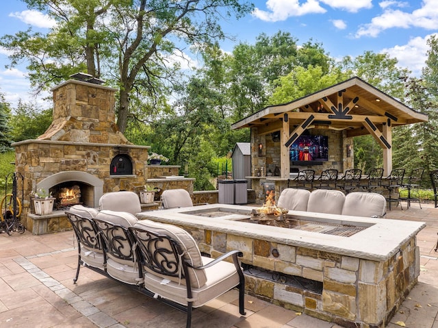 view of patio / terrace featuring an outdoor living space with a fireplace