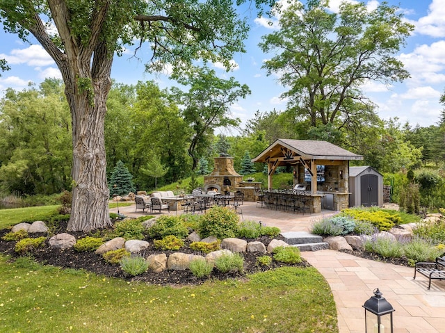 view of community with a patio, a storage unit, a yard, and a bar