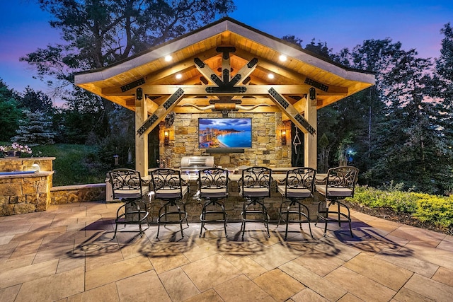 patio terrace at dusk featuring exterior bar