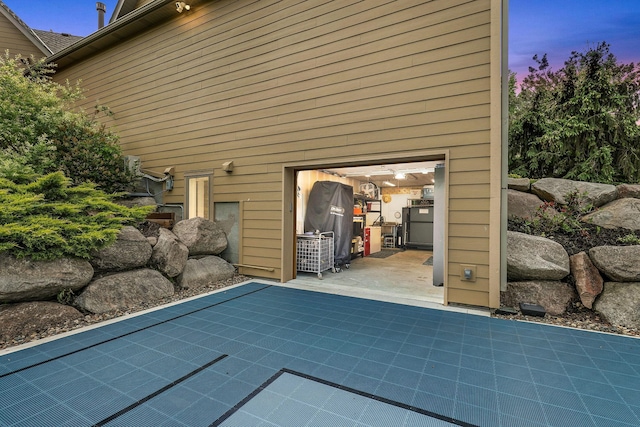 pool at dusk with a patio area