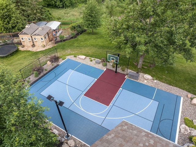 view of basketball court featuring a lawn