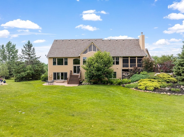 back of house featuring a patio and a lawn