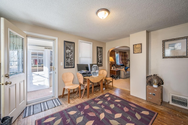 interior space featuring hardwood / wood-style flooring and a textured ceiling