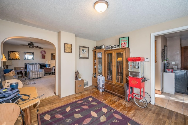 interior space with hardwood / wood-style floors, a textured ceiling, and ceiling fan