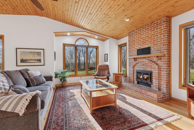 living room with vaulted ceiling, a wealth of natural light, and wooden ceiling