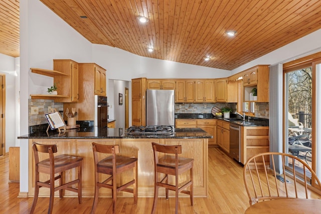kitchen with open shelves, decorative backsplash, appliances with stainless steel finishes, and a peninsula