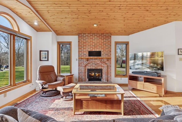 living room with wood finished floors, a fireplace, baseboards, wooden ceiling, and vaulted ceiling