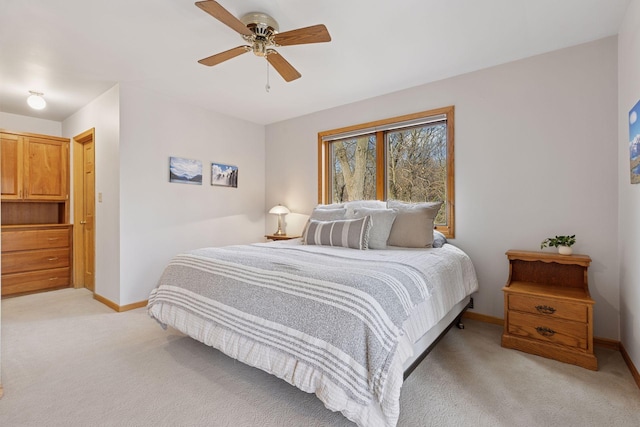 bedroom featuring baseboards, a ceiling fan, and light colored carpet