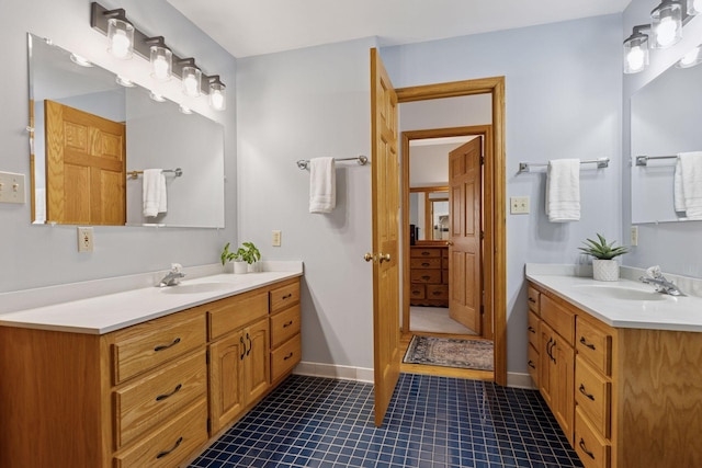 bathroom featuring tile patterned floors, two vanities, and a sink
