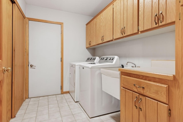laundry room with cabinet space, separate washer and dryer, and light tile patterned floors