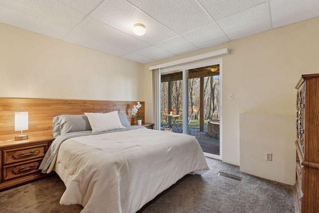 bedroom with visible vents, access to exterior, a paneled ceiling, and carpet