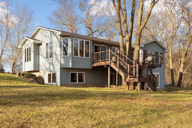 rear view of house featuring stairway, a deck, and a yard