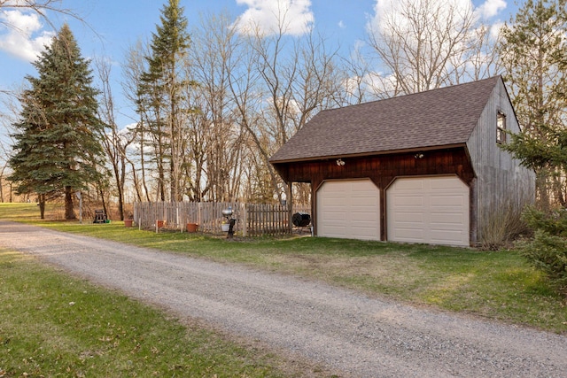 detached garage featuring fence