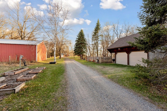 view of road with an outbuilding and gravel driveway
