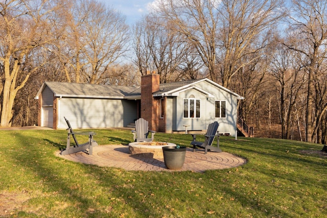 view of outbuilding with an outdoor fire pit and an attached garage