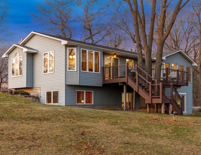 back of house with a lawn, stairs, and a deck