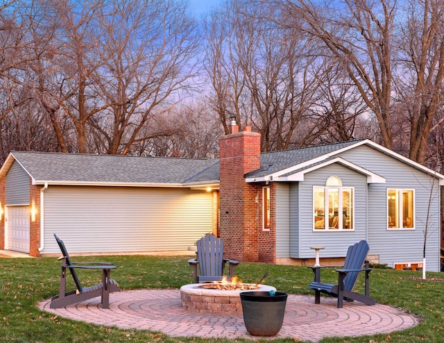 back of property featuring an outdoor fire pit, a patio area, a chimney, and a lawn