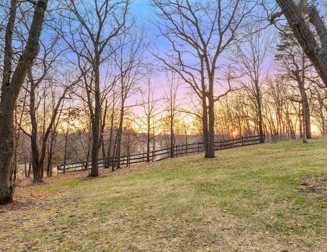 view of yard with a rural view and fence
