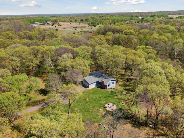 view of subject property with a heavily wooded area