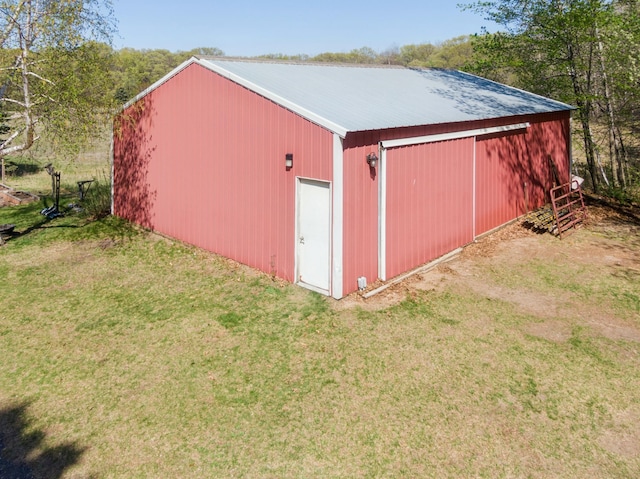 view of pole building with a lawn