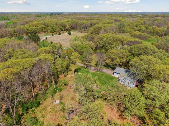 view from above of property with a heavily wooded area