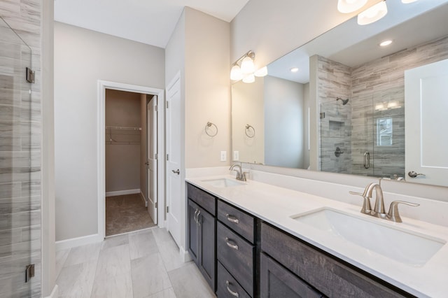 bathroom with vanity and a shower with shower door