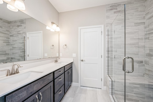 bathroom featuring vanity and a shower with shower door