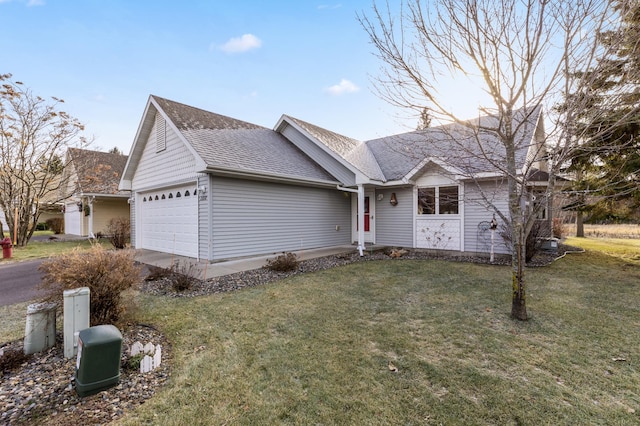 single story home featuring a garage and a front lawn