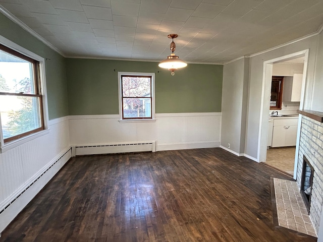 unfurnished room with a wealth of natural light, a baseboard radiator, and dark wood-type flooring