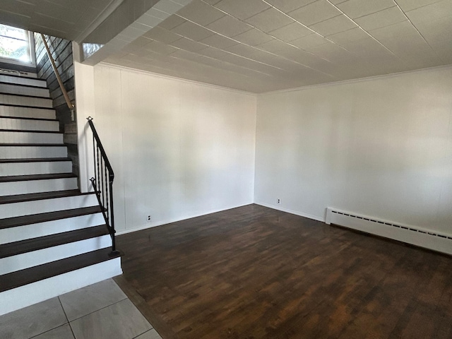 interior space featuring crown molding, hardwood / wood-style flooring, and baseboard heating