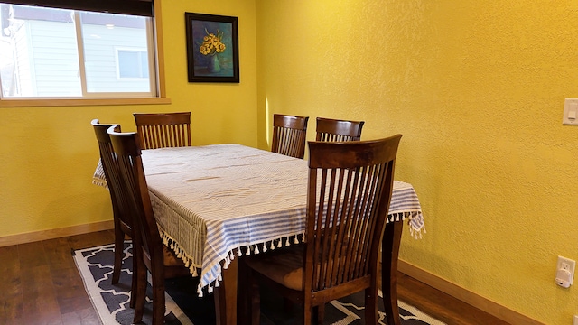 dining space with dark hardwood / wood-style floors