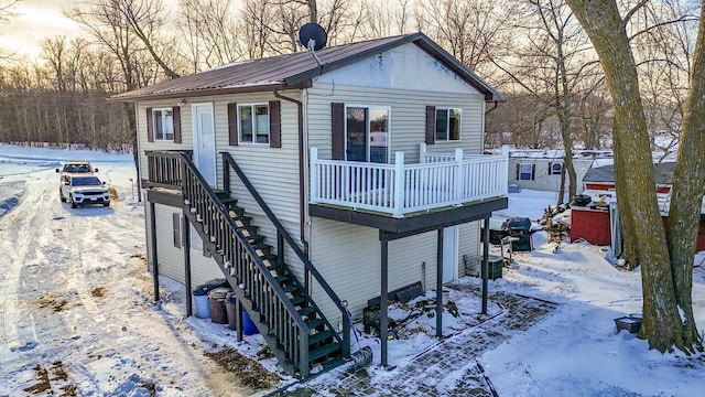 view of snow covered rear of property