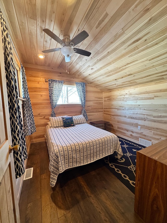 bedroom with lofted ceiling, ceiling fan, wooden walls, dark hardwood / wood-style floors, and wooden ceiling