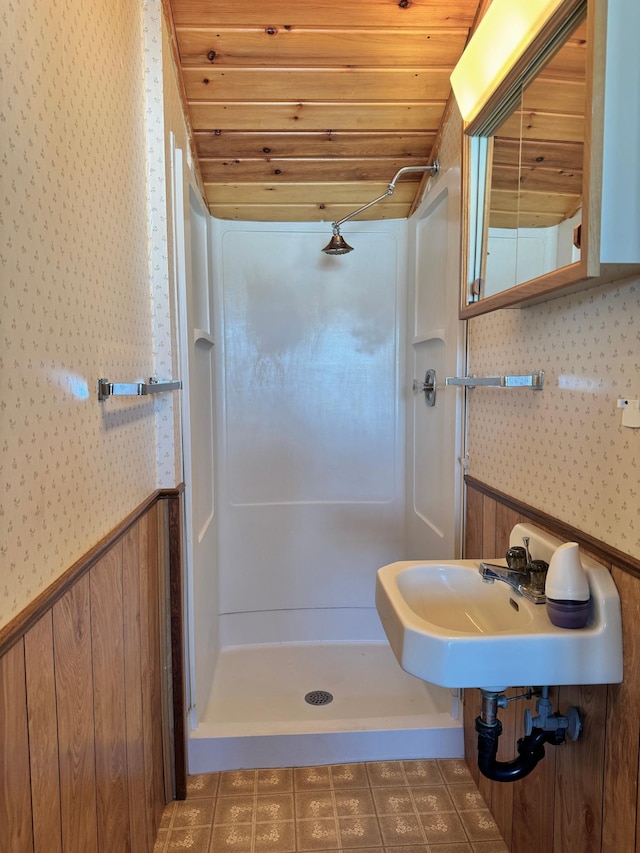 bathroom featuring wood ceiling, sink, and walk in shower