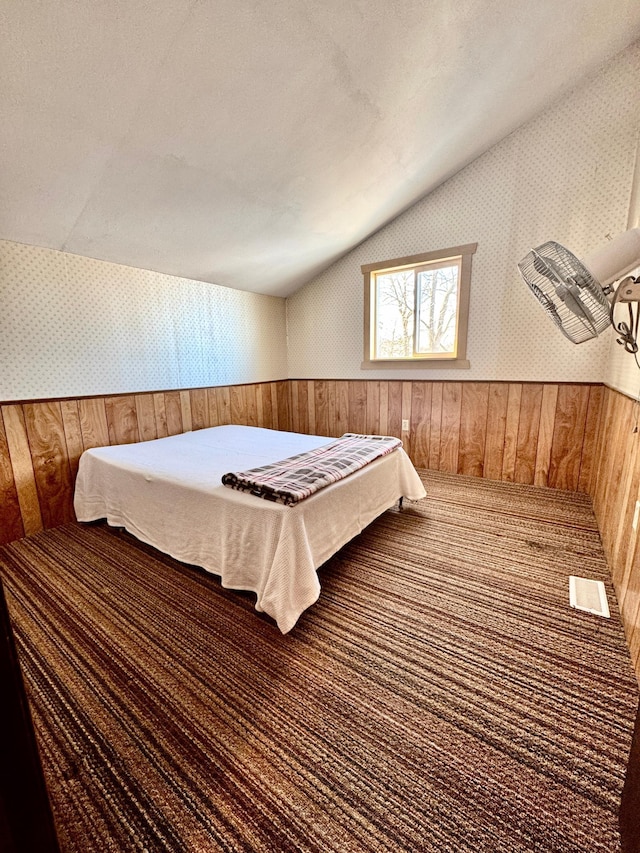 bedroom with vaulted ceiling and a textured ceiling