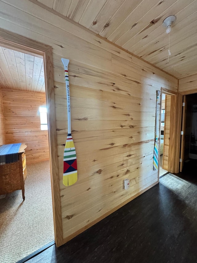 interior space featuring wood ceiling and wood walls