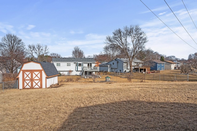 view of yard featuring an outdoor structure, a shed, and fence