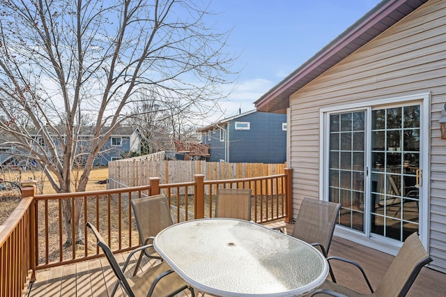 deck featuring outdoor dining space and fence