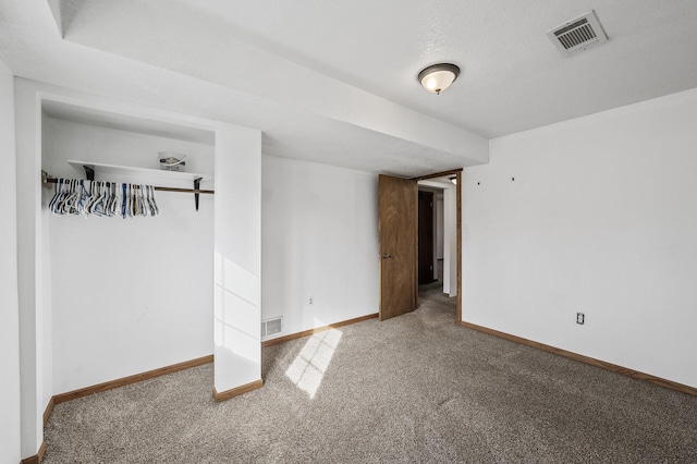 carpeted empty room with baseboards and visible vents