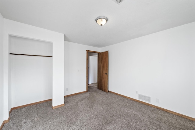 unfurnished bedroom featuring a closet, visible vents, carpet flooring, and baseboards