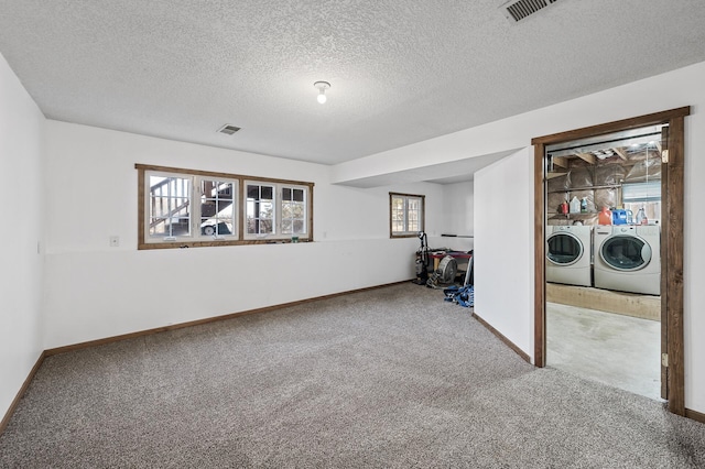 basement with visible vents, baseboards, separate washer and dryer, and carpet